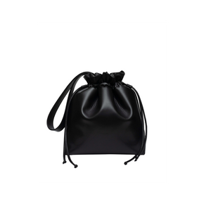 Large vegan leather shoulder tote in black with black strap and string closure.