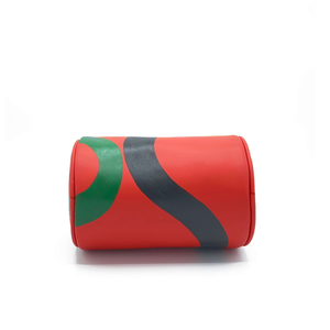 Vegan leather duffle style mini bag with detachable crossbody strap in red with hand painted squiggles in black and green.   Bottom detail.